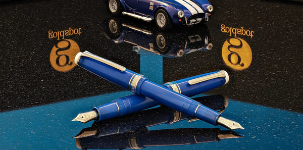 Two blue fountain pens.